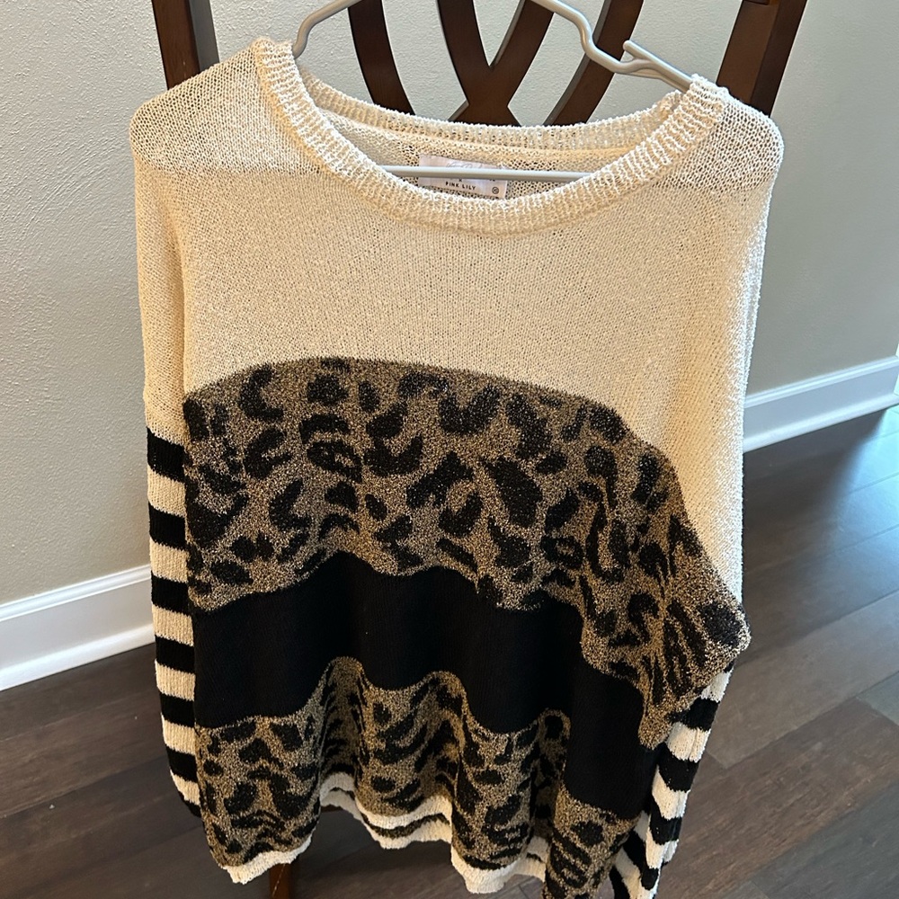 Cheetah print sweater. Never worn.